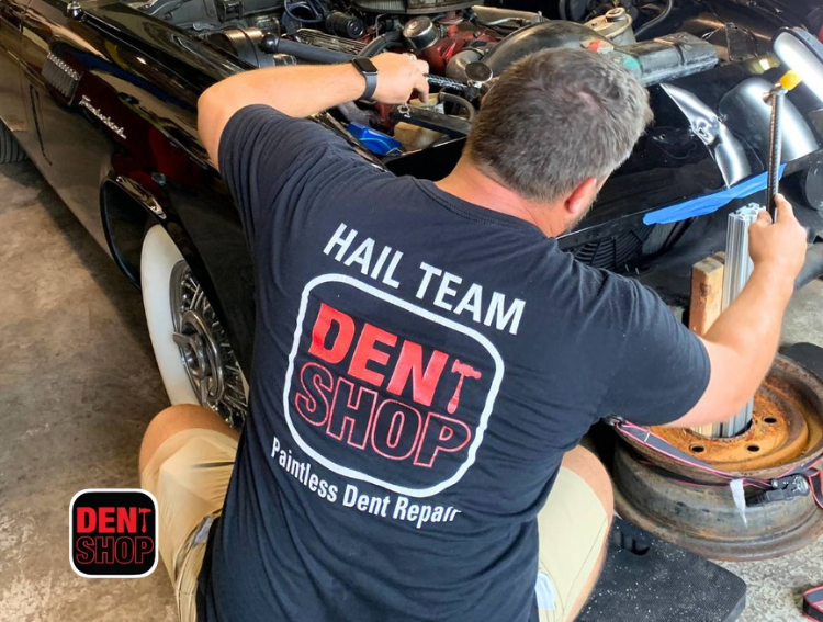 man fixing dent at dent shop